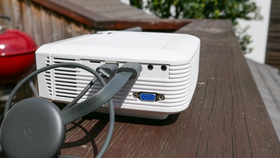 Photo of a Google Chromecast plugged into an Apeman projector