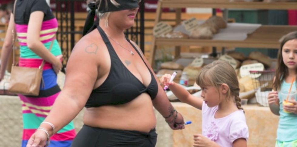 Woman Strips Off Clothes In Public and Asks Strangers to Write On Her. She’s Making a Point.