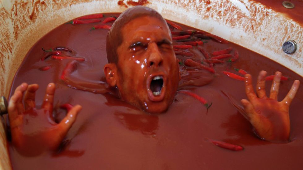 Guy Jumps Into Tub Full Of 1,250 Bottles Of Hot Sauce