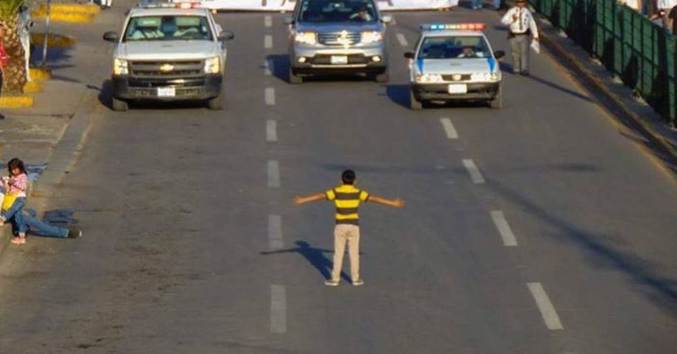 Powerful Photo Shows A Young Boy Standing Up Against Thousands Of Anti-Gay Protesters
