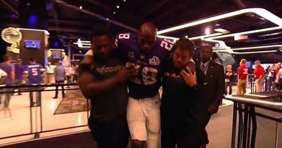 Adrian Peterson Escorted Through A Bar After Knee Injury