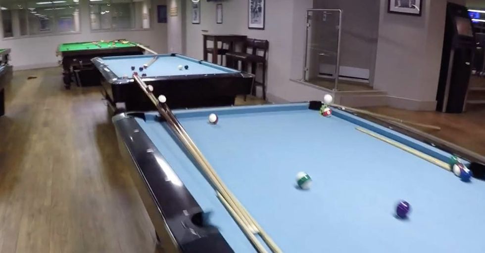 This Jaw-Dropping Trick Shot Requires a Putter, Nine Pool Tables, A Staircase, And A Bar