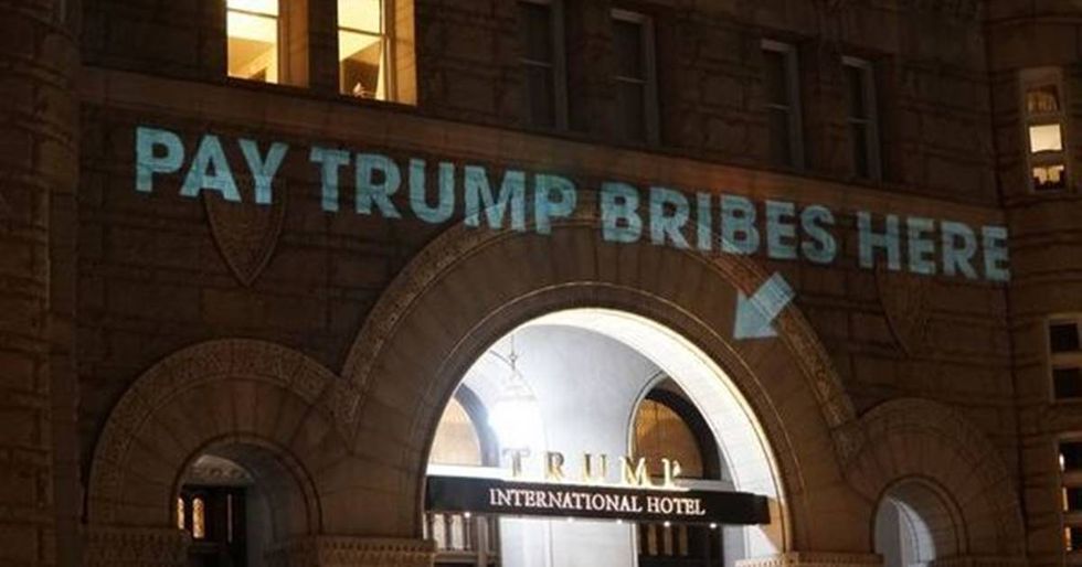 Artist Calls Out Trump’s Conflicts Of Interest By Projecting Them Onto His Hotel