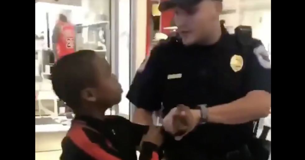 Woman fights back against cop harassing her 12-year-old nephew for selling his rap CD at the mall