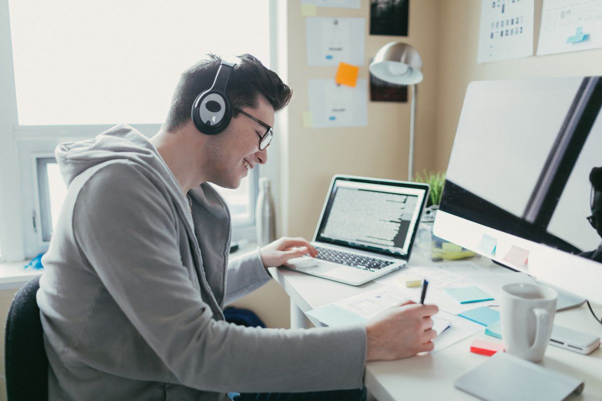 Stock photo of a college student working in dorm room