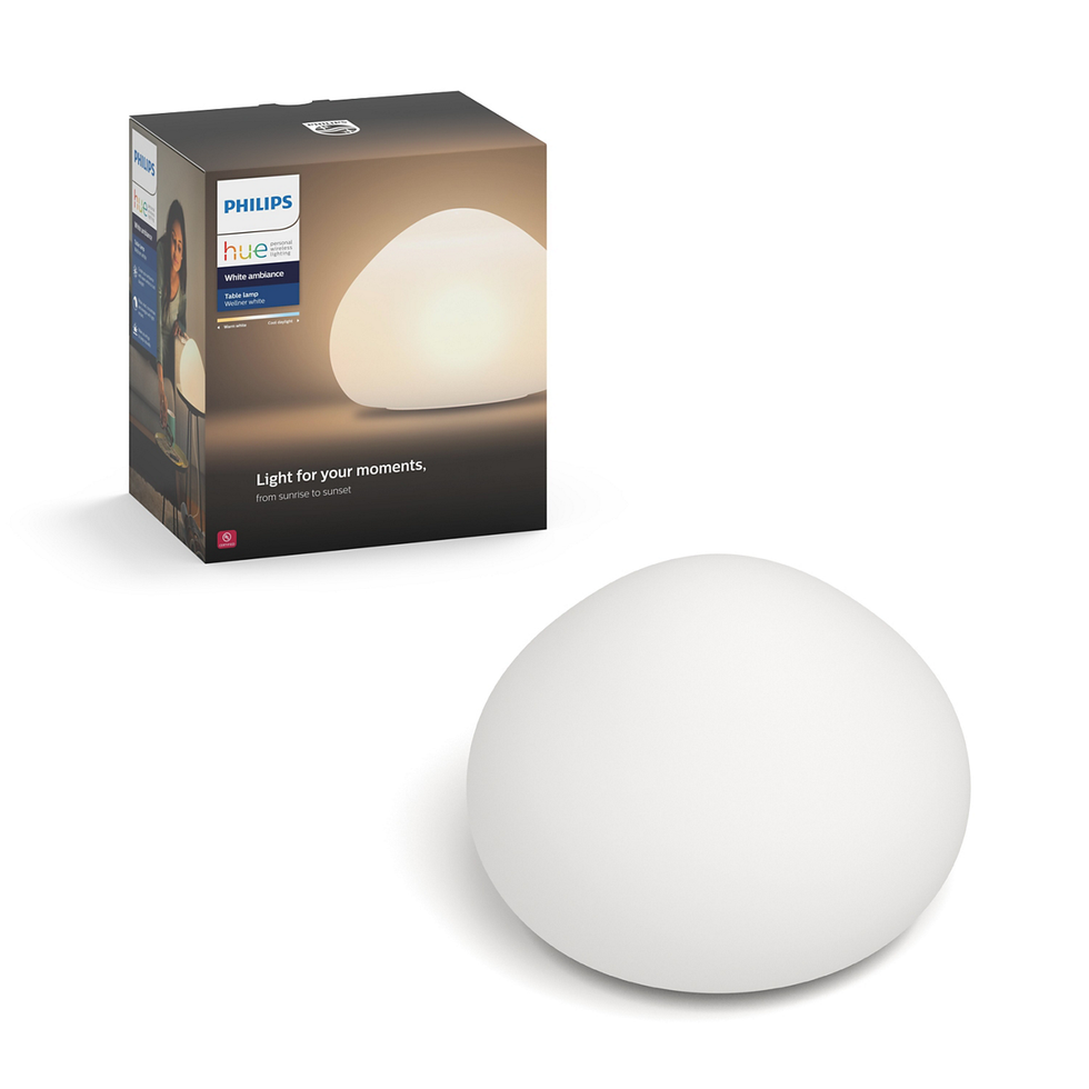 A box that says 'Philips hue' and the lamp next to it, that looks like a white rock, smooth and tear-dropped shaped at top