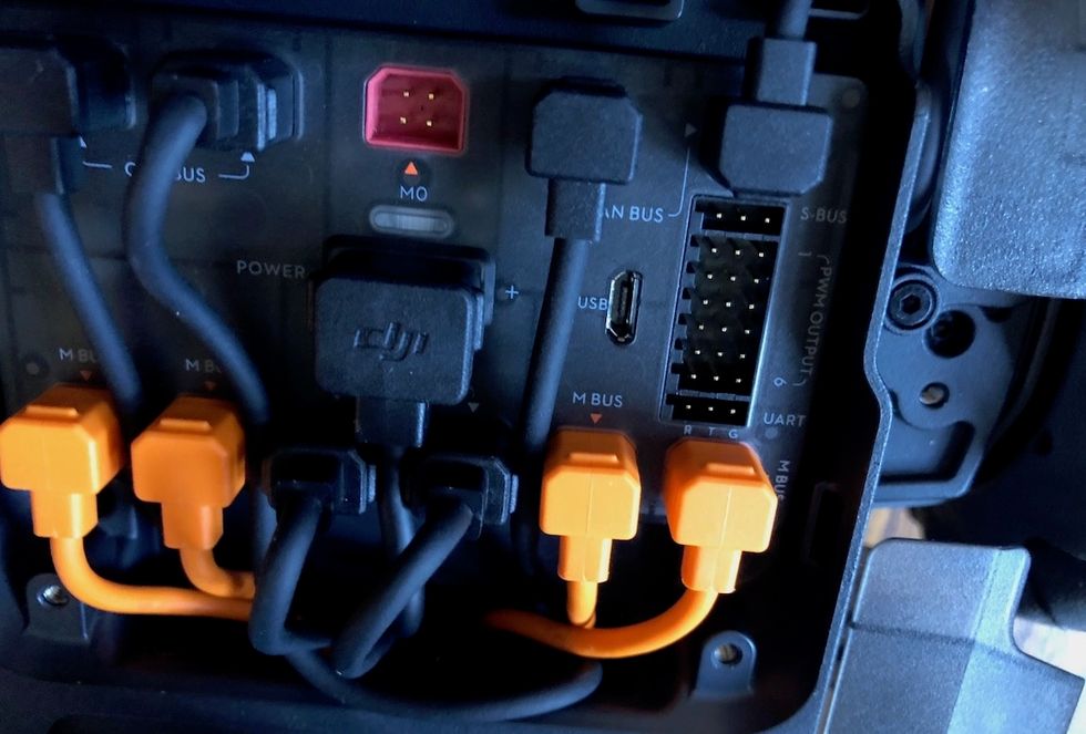 A photo of wires connected to ports and the letters 'DJI' in the center