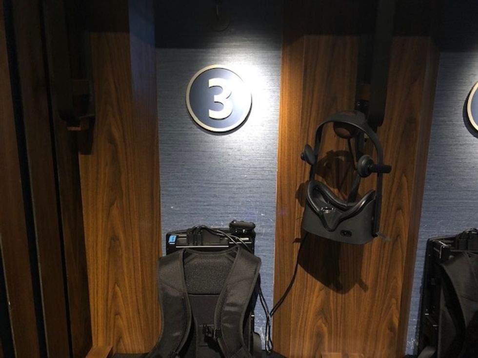A small cubby with the number '3' inside, and a black Oculus Rift headset and backpack shown