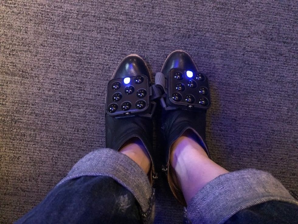 Black tracking devices that have one light strapped on to a pair of shoes