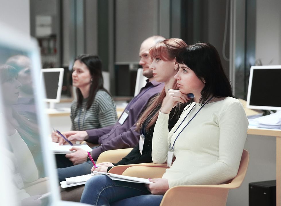 Curious professional attends training about new office technology