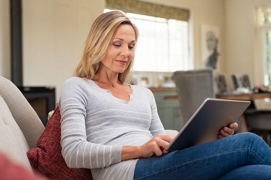 Professional woman uses tablet to read work email