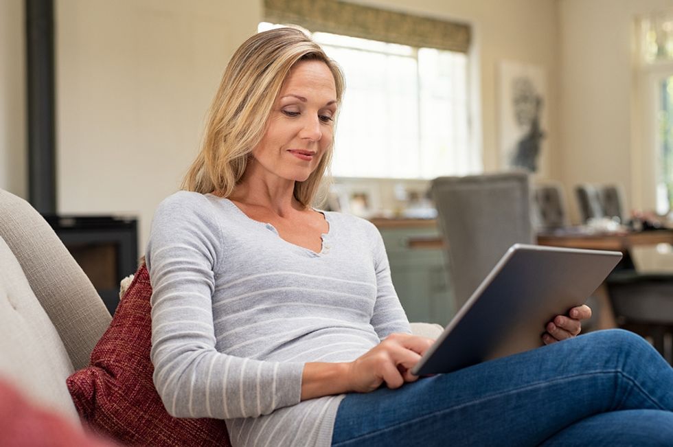 Professional woman uses tablet to read work email