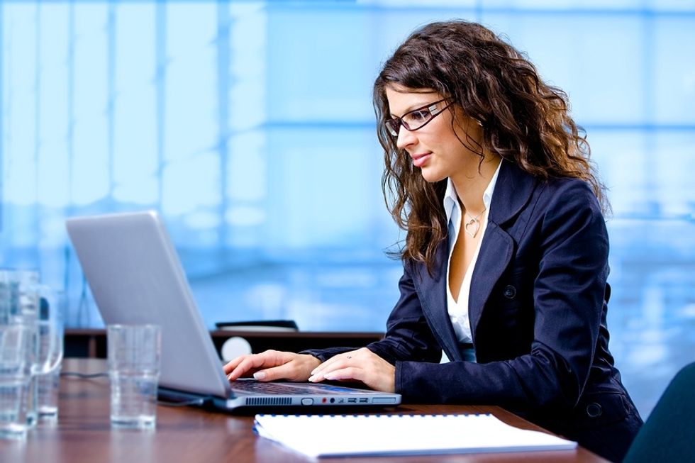 Professional woman sending someone an invitation to connect on LinkedIn