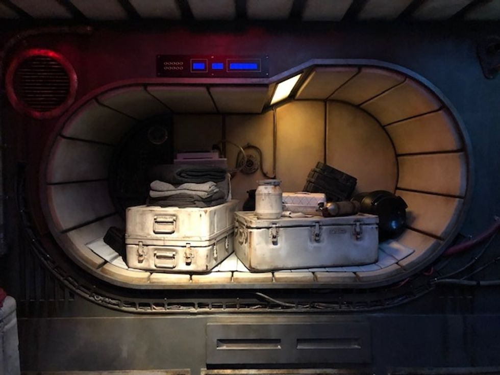 Silver metal cases, canisters and blankets in a storage bay