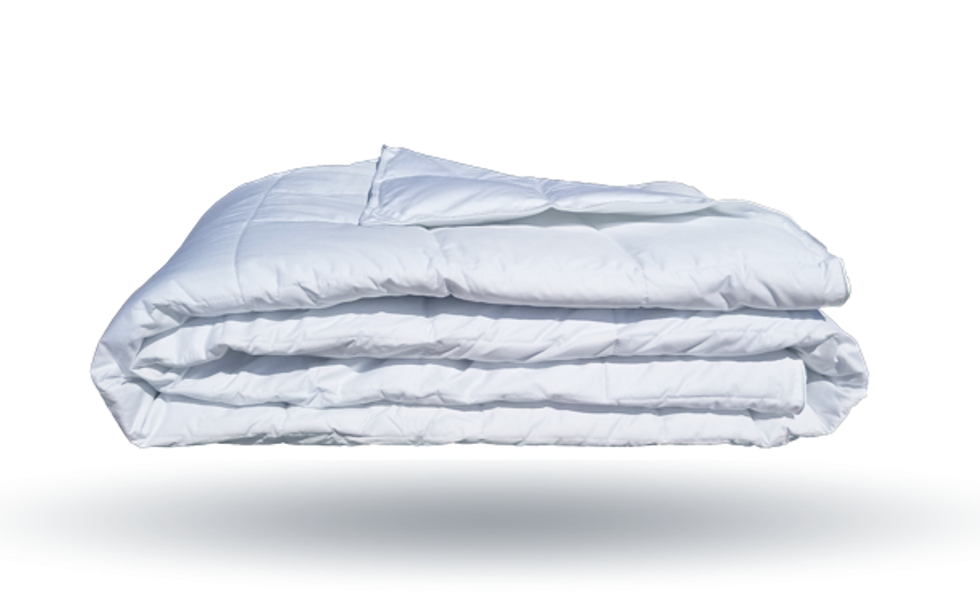 A white, fluffy comfortable folded in quarters and appearing to float in air