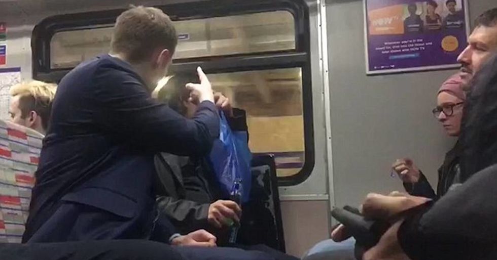 A drunk man was filmed harassing an immigrant on a train. The woman next to him responded in the most British way.