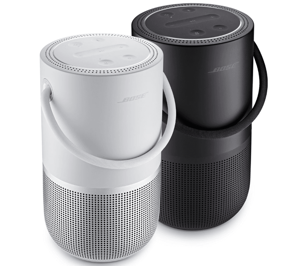 Two speakers side by side, one in black, one in white, with handles