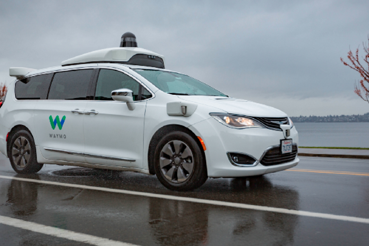 Photo of Waymo driverless car on wet road