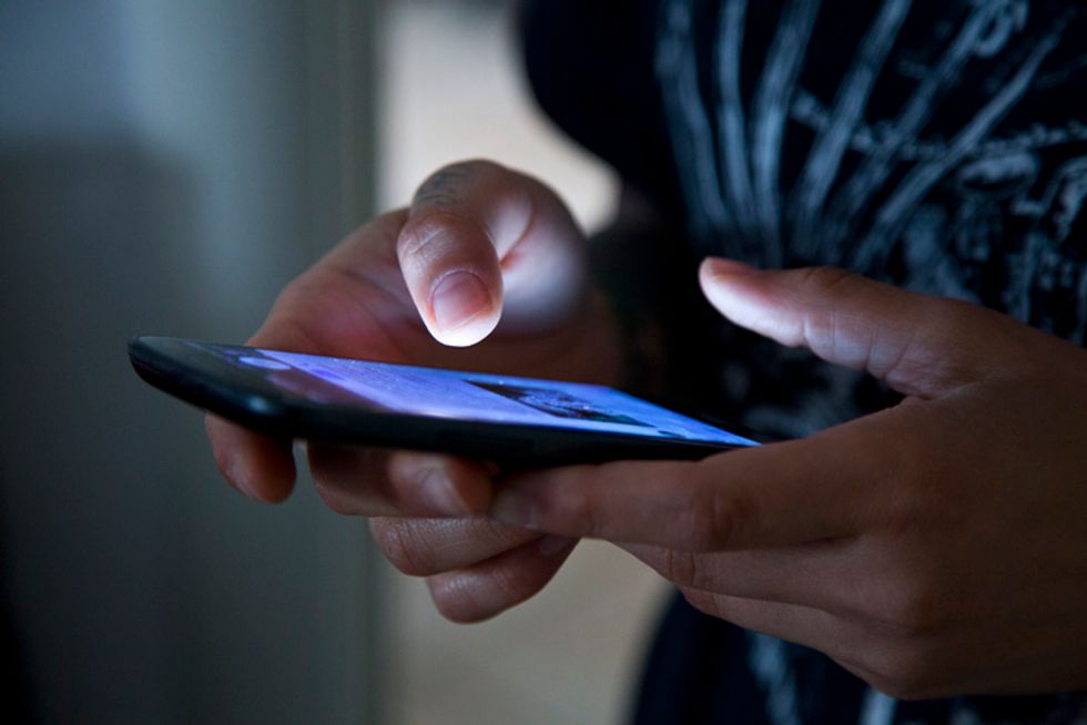 A hand holding a smartphone