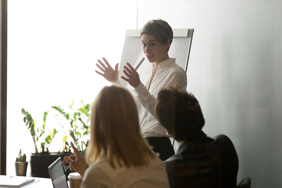 Female boss using her leadership skills at a work meeting.