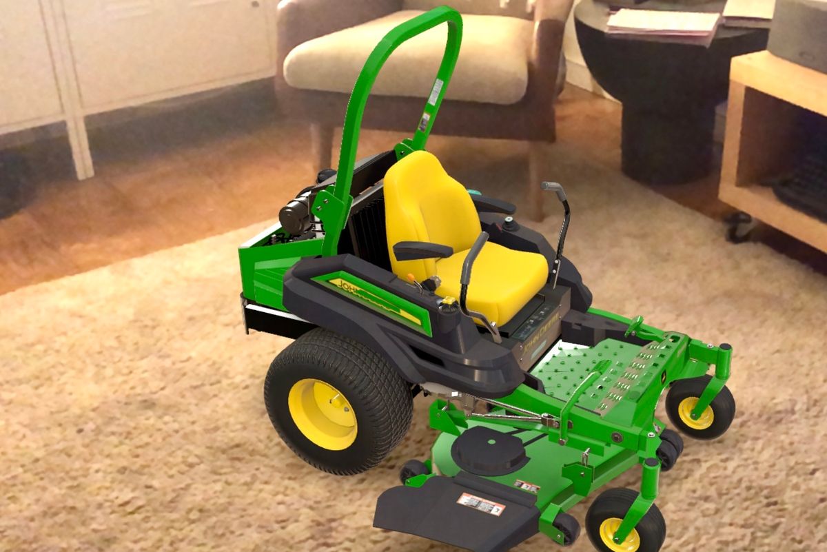 An image of a green and yellow John Deere lawn mower in the middle of a living room