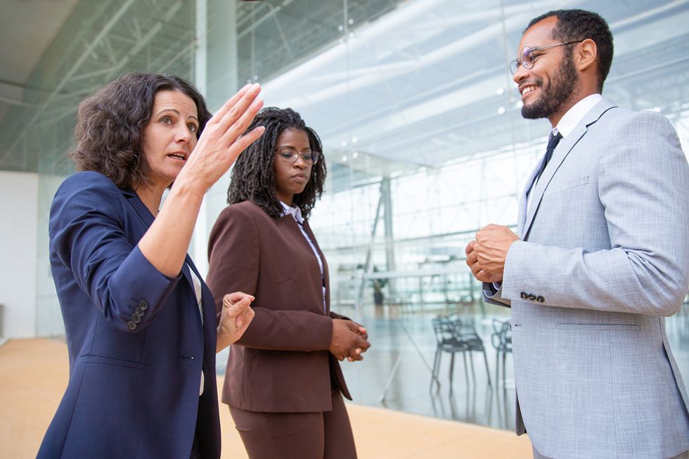 Manager using her soft skill of clear communication to lead two members of her team.