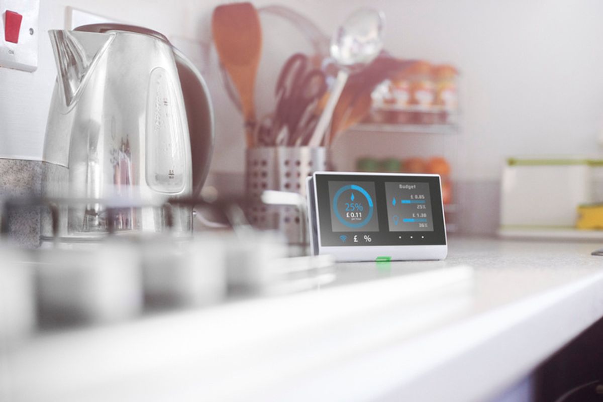 Kitchen kettle with a smart video screen next to it