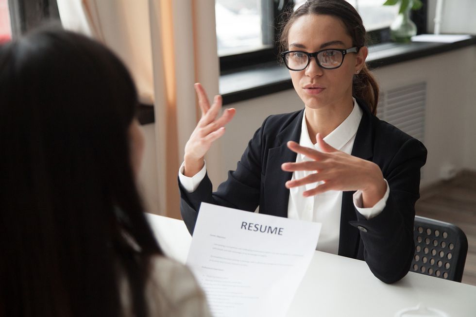 Professional woman answers behavioral interview questions during a job interview
