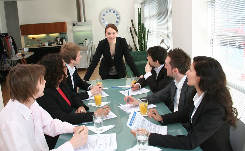 Female boss striving to push the envelope at work and displaying her leadership skills at a work meeting.