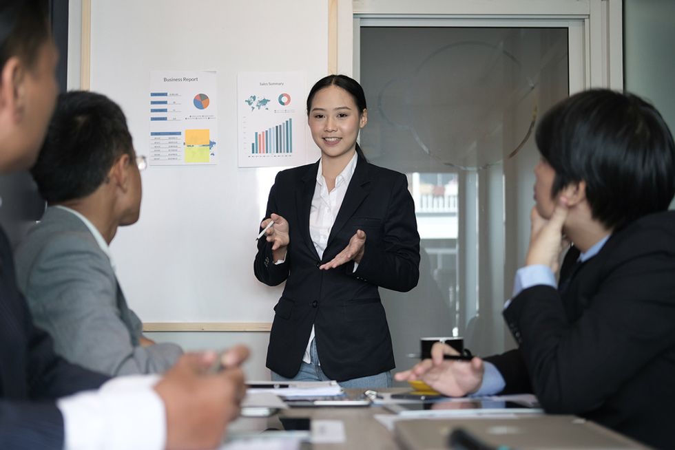 Female leader using her personal leadership skills to lead a work meeting.