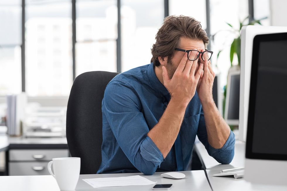 Man upset about the news he just lost his job and now isn't sure what to do.