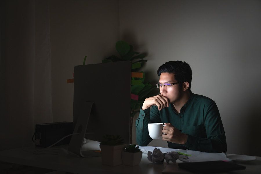 Unemployed man researching Work It Daily's career growth club.