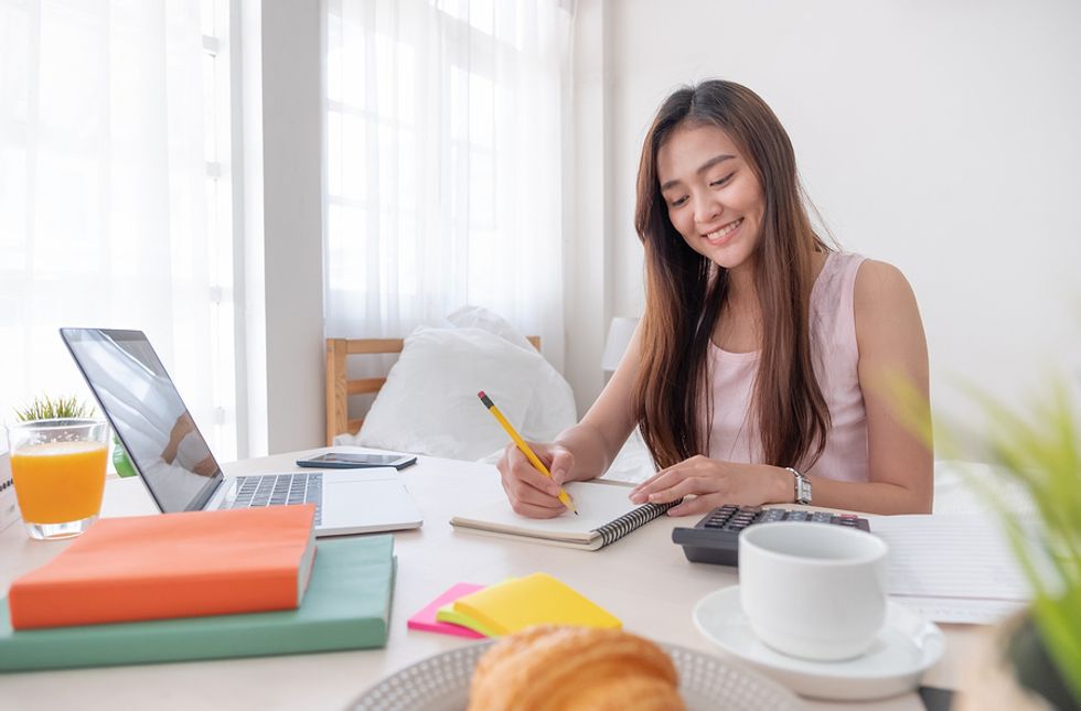 Woman working on tailoring her resume for a leadership role.