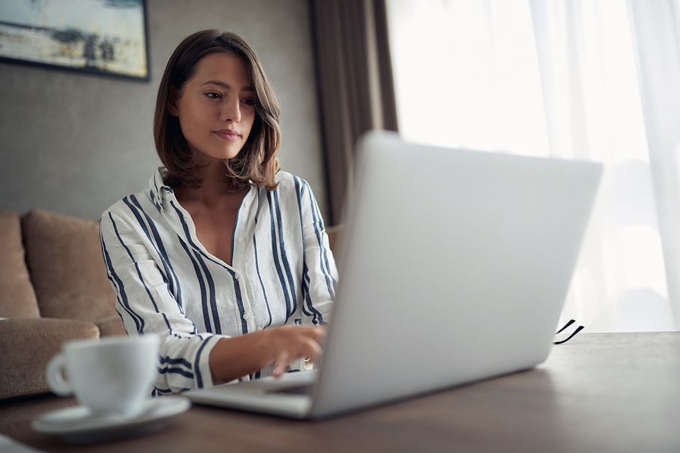 Woman looking over her resume and tailoring it for a leadership position.