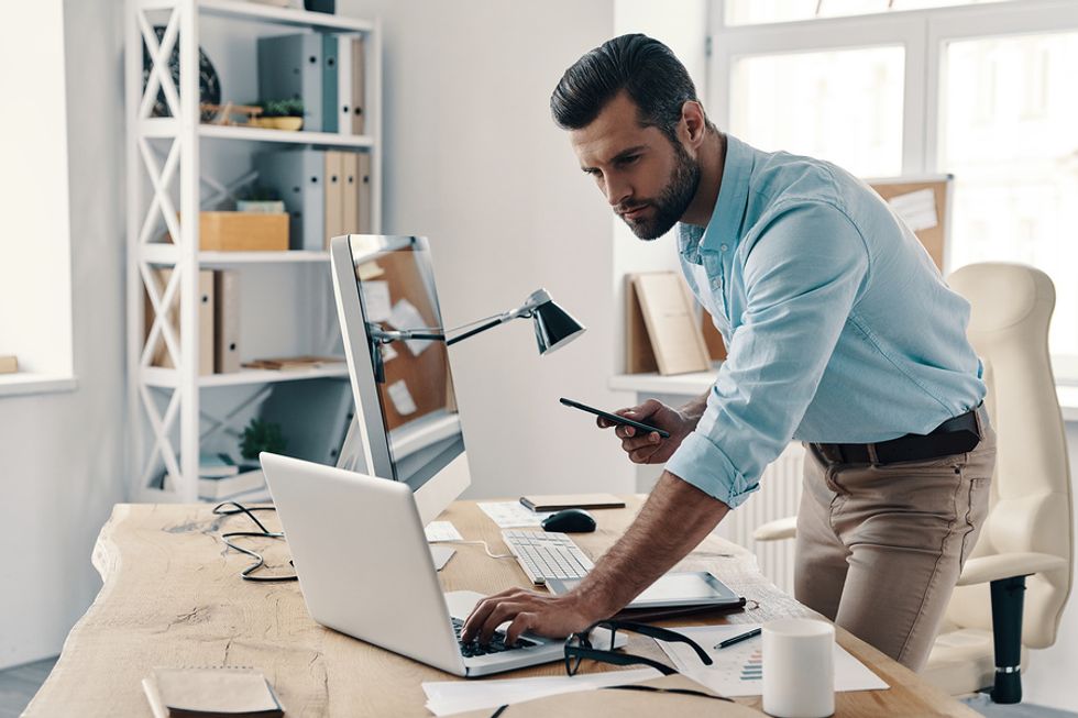 Man fixing his resume and tailoring it for a leadership role.