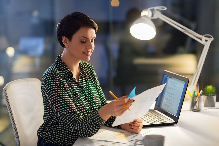 Woman reviewing her resume and tailoring it for a leadership role.