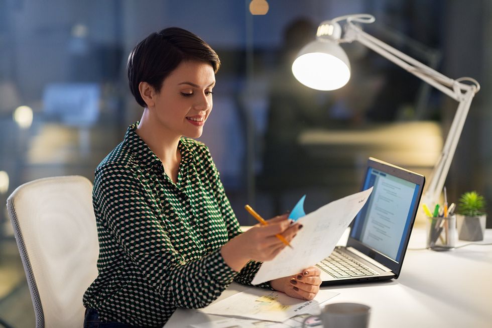 Woman reviewing her resume and tailoring it for a leadership role.