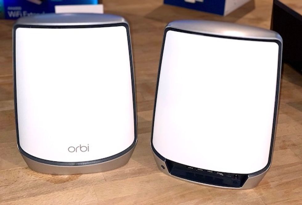 Two large white Wi-Fi devices with the word "orbi" on one