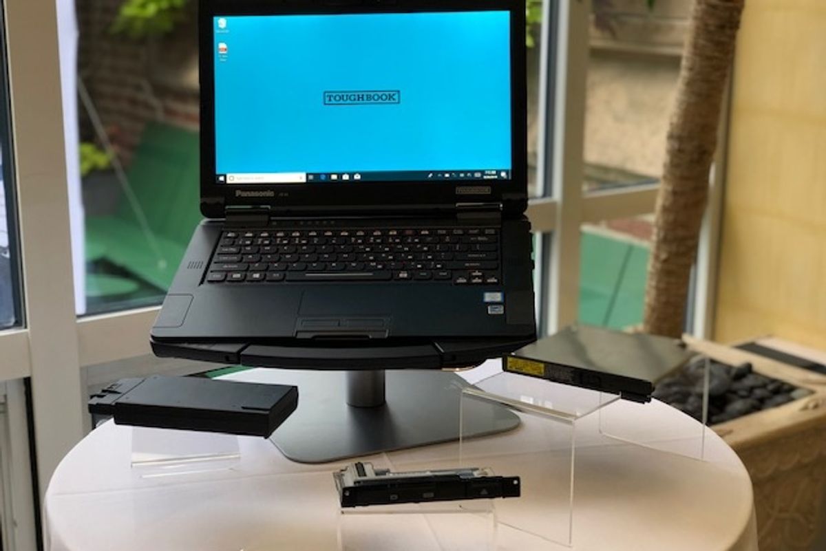 A black laptop computer with a blue screen and the word, 'Toughbook' on the front