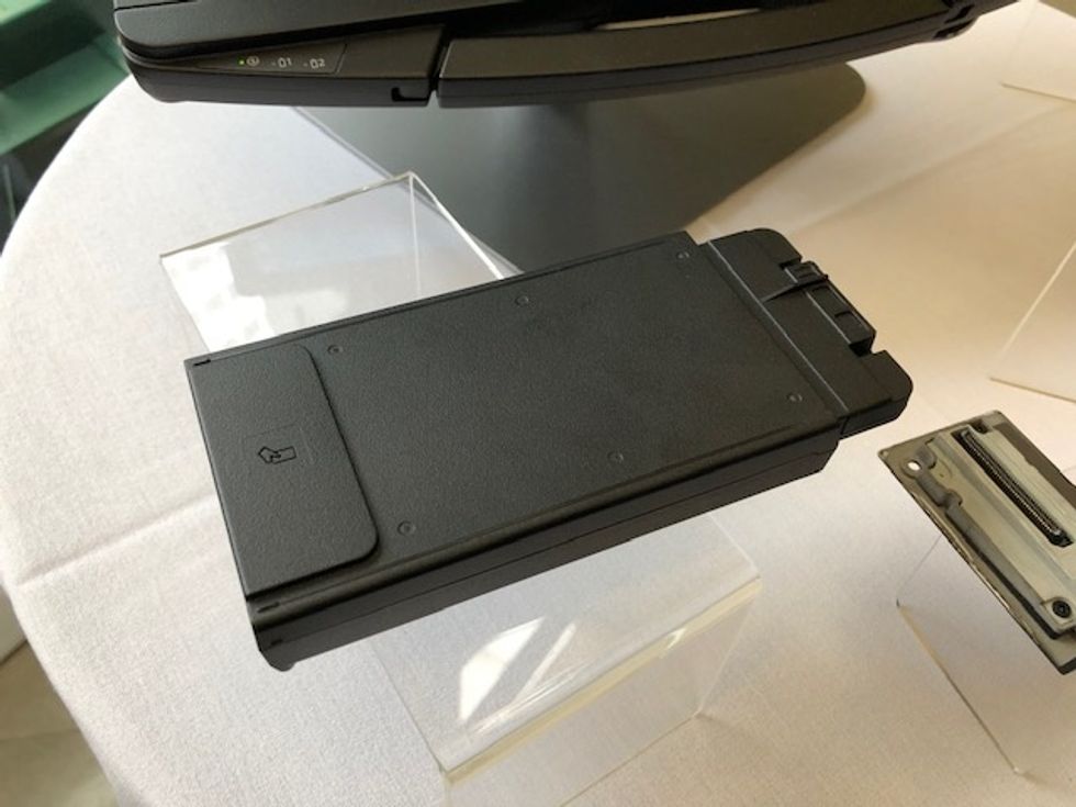 A black modular plastic computer piece on top of a table