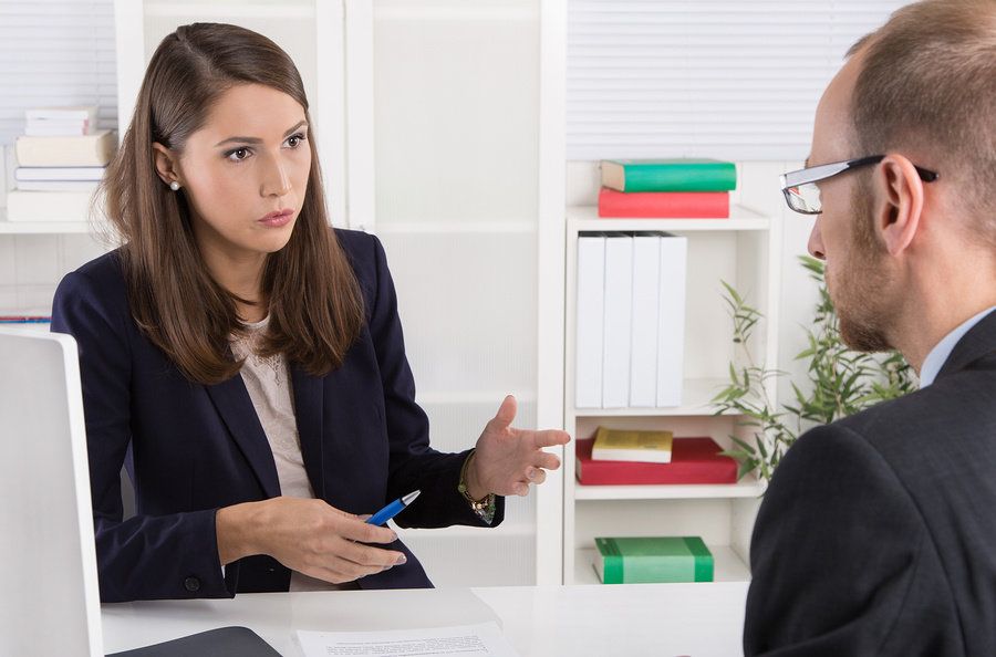 Interviewer asks a job candidate questions to find out if they can take feedback