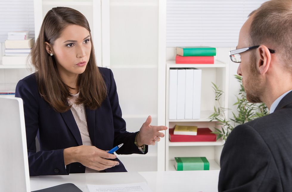 Interviewer asks a job candidate questions to find out if they can take feedback
