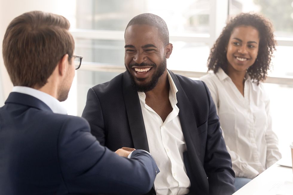New associate shares a laugh with his boss.