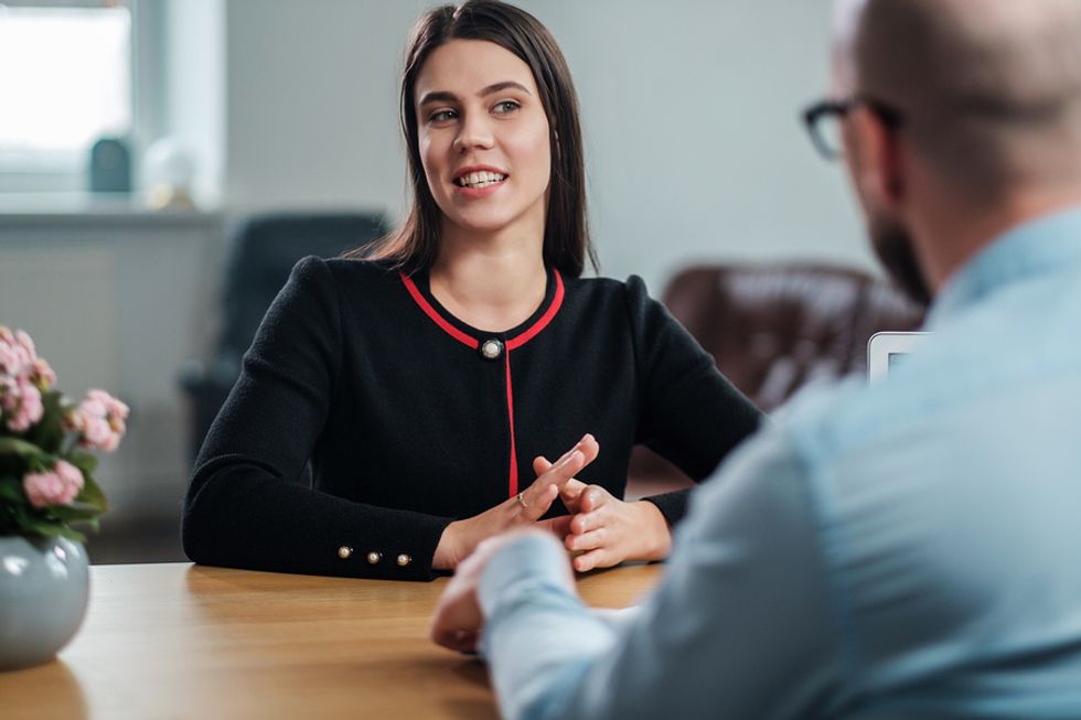 Job candidate answers the question, "Why should we hire you?" during an interview