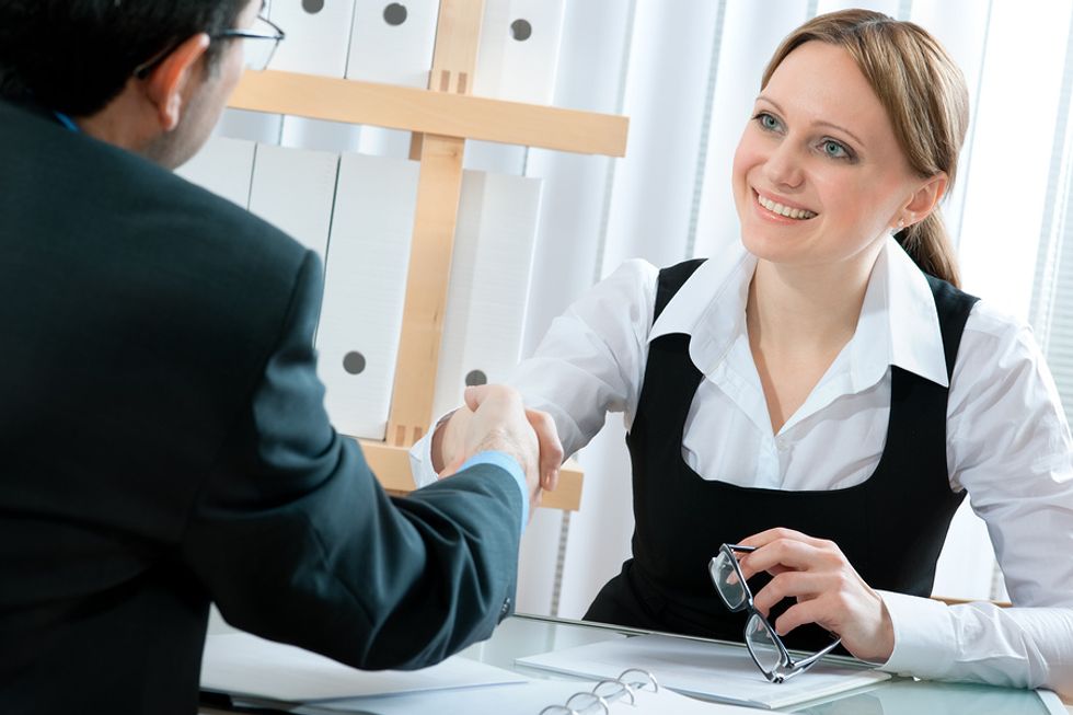 Young woman remains positive during difficult job interview questions.