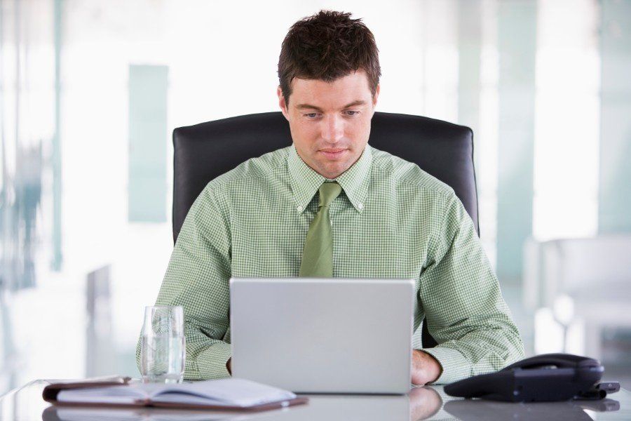 Young business man setting work goals for himself in order to be happier at work.