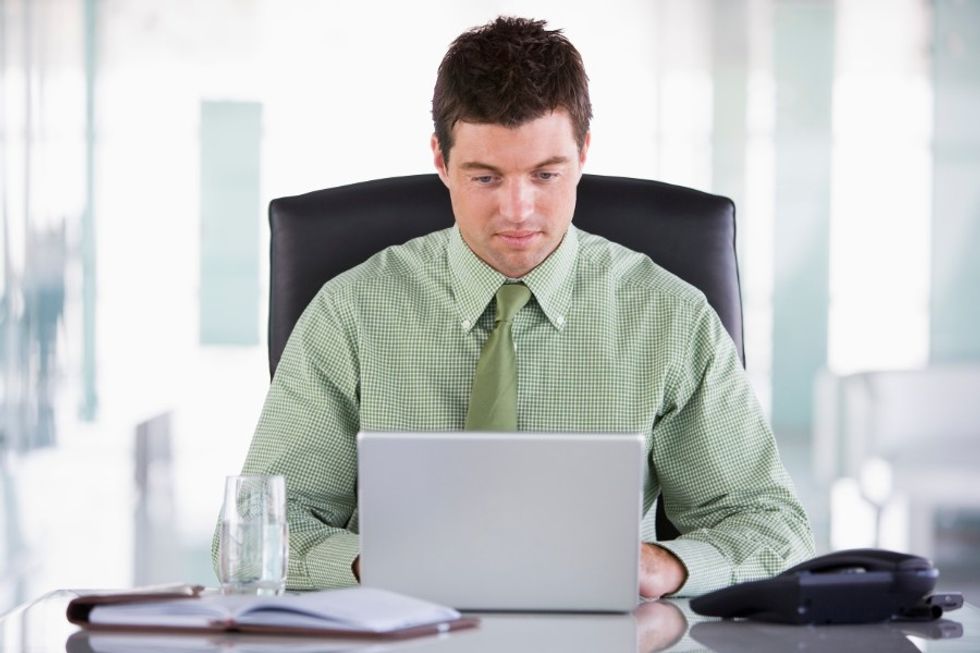 Young business man setting work goals for himself in order to be happier at work.