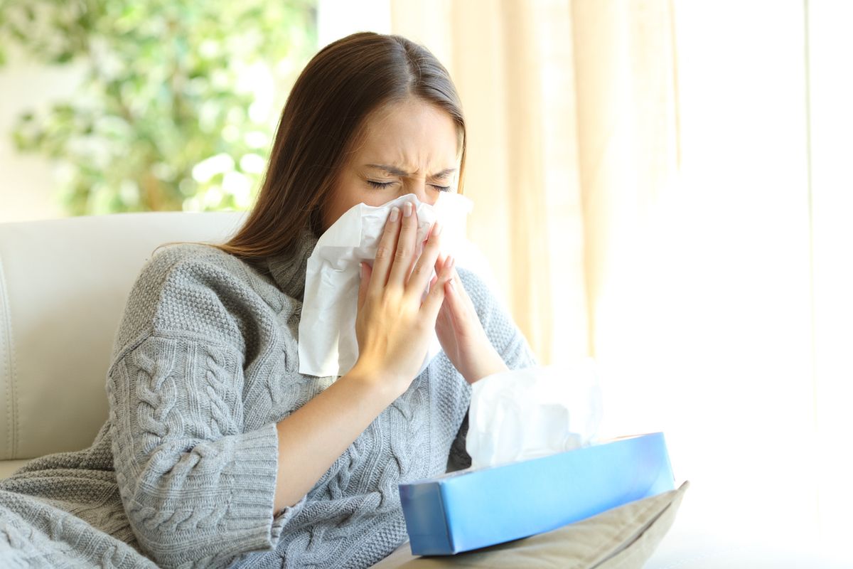 Stock image of a woman sneezing