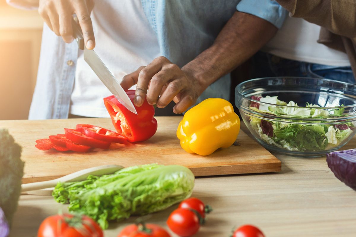 Stock image of a man chopping vegetables