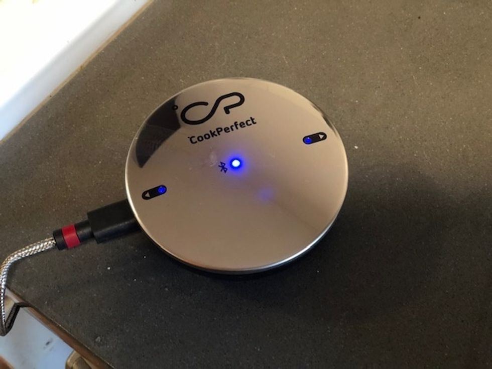 CookPerfect sitting on a stove top with a blue light on top